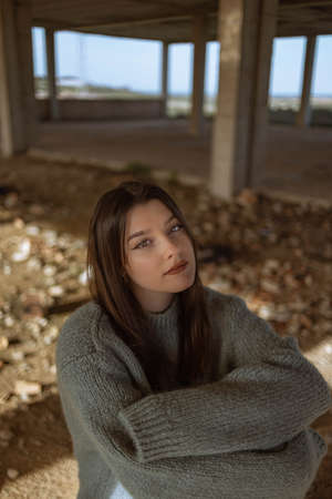 Portrait young woman on the street. Blue-eyed woman. Youth fashion. Urban style. Woman in a building under constructionの写真素材