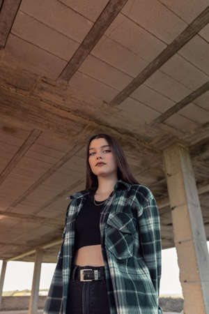 Portrait young woman on the street. Blue-eyed woman. Youth fashion. Urban style. Woman in a building under constructionの写真素材