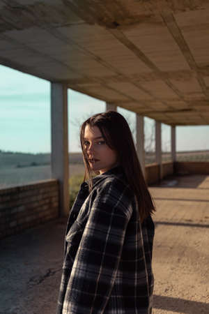 Portrait young woman on the street. Blue-eyed woman. Youth fashion. Urban style. Woman in a building under constructionの写真素材