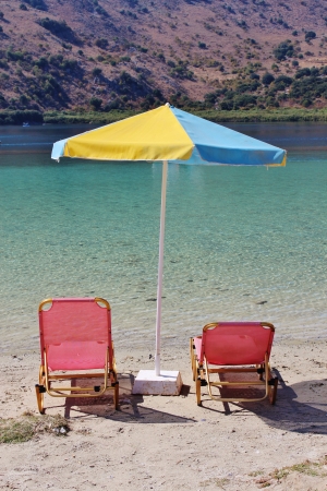 Sunbeds and parasol, Kournas Lake, Creteの写真素材