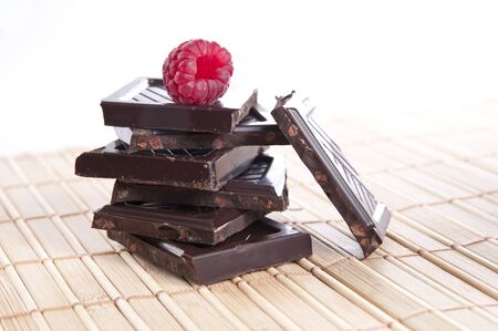 Bar of chocolate with a raspberry on top の写真素材