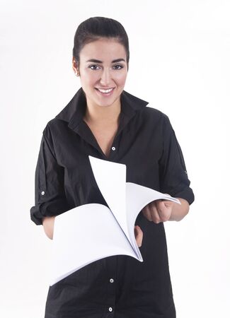 Smiling young girl turning over the pagesの写真素材