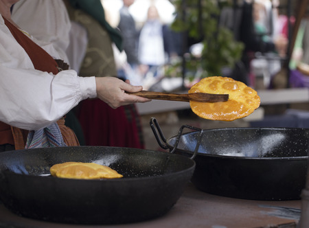 Frying torto de maiz (Corn bread is a typical food in Asturias)