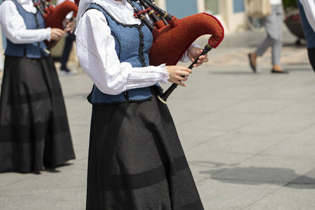 Woman playing bagpipe, spanish traditional dance groupの写真素材