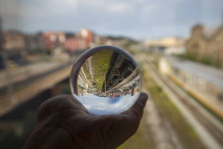 Railroad tracks are reflected over a glass ball