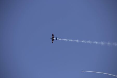 Small airplanes doing aerial acrobatics in a exhibitionの写真素材