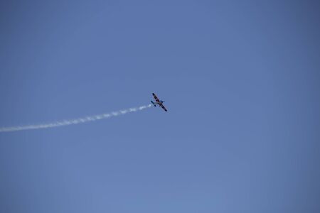 Small airplane doing aerial acrobatics in a exhibitionの写真素材