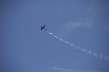 Small airplane doing aerial acrobatics in a exhibitionの写真素材