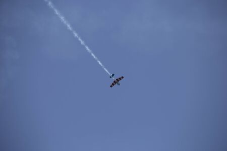 Small airplane doing aerial acrobatics in a exhibition