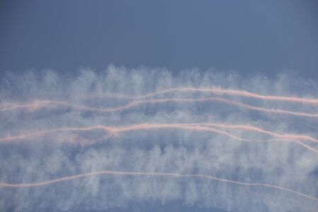 Trail of colorful smoke left behind by planes during an air showの写真素材