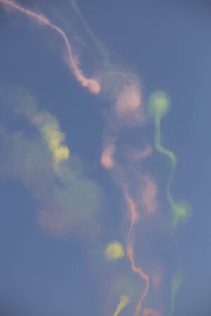 Trail of colorful smoke left behind by plans during an air showの写真素材