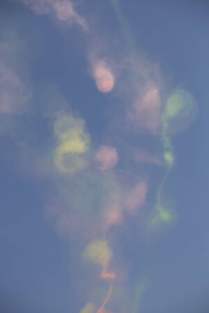 Trail of colorful smoke left behind by plans during an air showの写真素材