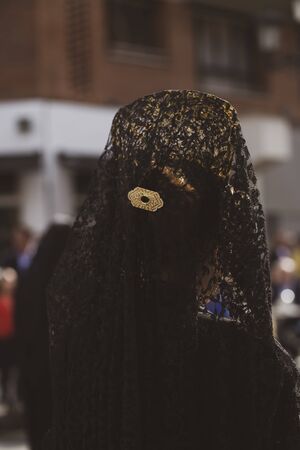 Rear view of "manolas" in a procession, Holy Weekの写真素材