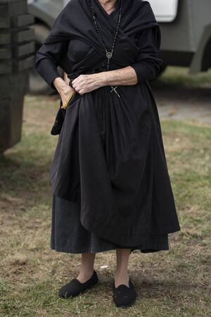 Woman in mourning with a rosaryの写真素材
