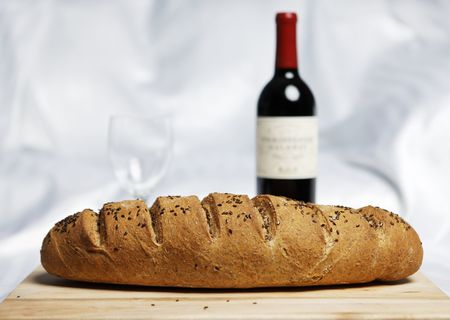 fresh bread baked with soft backgrounf of wine and glassの写真素材
