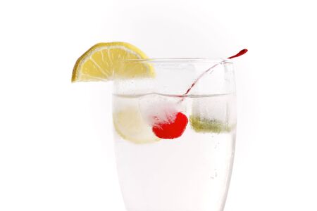 glass of water with frozen fruit inside the ice cubeの写真素材