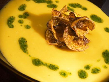 yellow soup cream with potato chip の写真素材