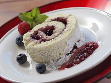 sweet swiss cake on a plate with fruit and jam. Shallow depth of field. の写真素材