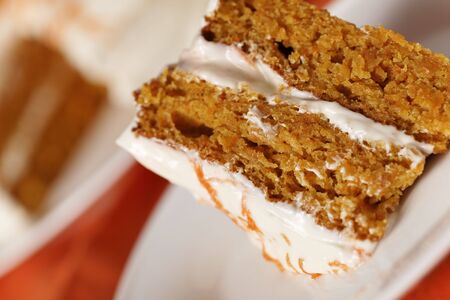Homemade carrot cake dessert on white plate.Very shallow depth of field.