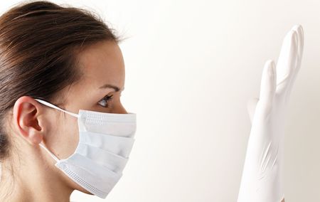 woman with brown hair and a medical mask for protection again influenza. Shallow depth of field. Copy space for your text.の写真素材
