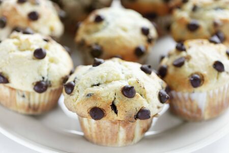 delicious homemade muffins with chocolate chips on it. Selective sepia tone and very shallow depth of field.の写真素材