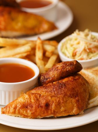 Roast chicken quarter breast with french fries, cole slaw salad and bbq sauce on the side. Shallow depth of field.の写真素材