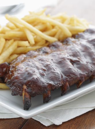 baked ribs with french fries on the side. Meat meal. の写真素材