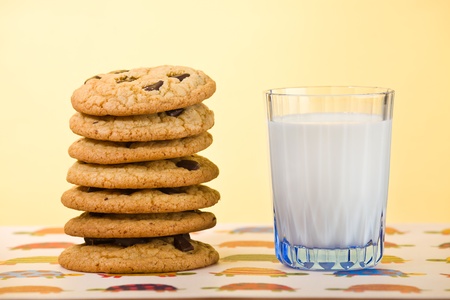 Butter cookie stacked with chocolate chip and milk on the side. Very shallow depth of field.の写真素材