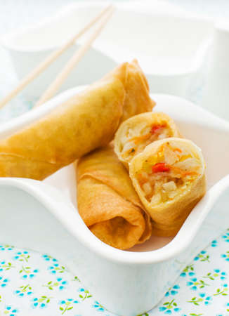 Close up spring roll in a white bowl. 