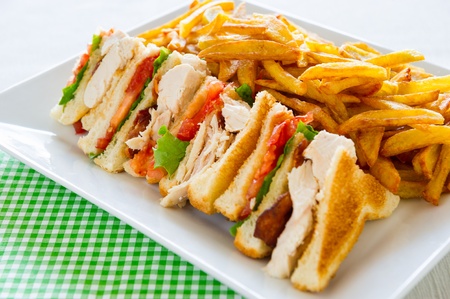 Chicken club sandwich in a white plate. Meal time.の写真素材