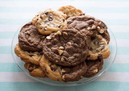 Homemade chocolate chips cookies on a plate with a white and blue background. Sweet food.