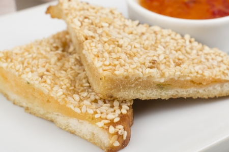 Hatosi (Prawn Toast) - Chinese sesame shrimp toast served with sweet chili sauce. Close upの写真素材