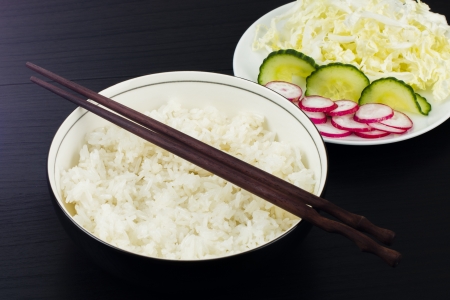 Japanese steamed rice served with radish, cucumber and cabbage salad の写真素材