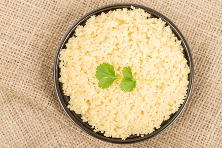 Couscous - Moroccan lemon couscous garnished with coriander leaves  Overhead shot 