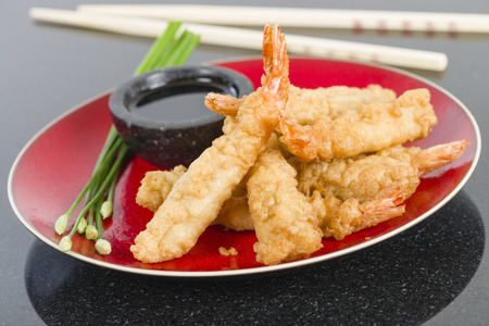 Ebi Tempura - Prawn tempura served with soy sauce on a granite background.の写真素材