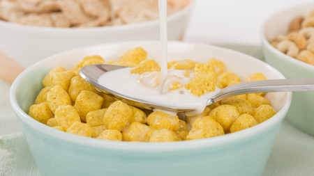 Golden Nuggets - Whole grain cereals in a green bowl.の写真素材