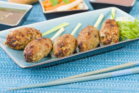 Nem Nuong Xa - Vietnamese minced pork sausages on lemongrass skewers served do chua, nouc cham and chili sauce.の写真素材