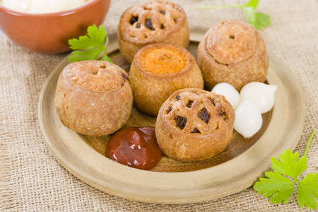 Pork Pies - Selection of pork pies Melton Mowbray, with pickle and chorizo served with pickled onions and brown sauce.の写真素材