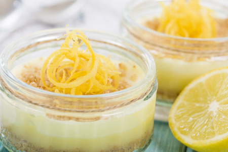 Mango  Passion Fruit Cheesecake - Individual potted dessert made with mango and passion fruit whipped cream and a biscuit base, topped with passion fruit pulp.の写真素材