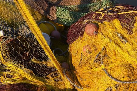 Fishing nets left to dry on the harbour wall.