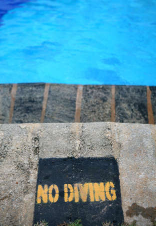 No diving sign at a swimming pool (shallow DoF)の写真素材