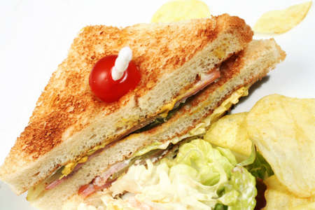 A club sandwich with potato chips, coleslaw and salad.の写真素材