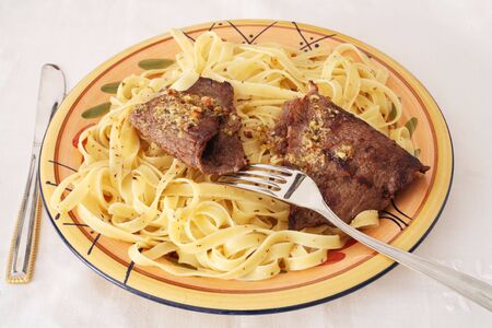 Beef escaopes with pasta and fettucini の写真素材