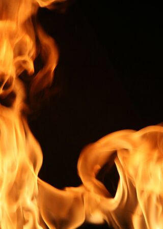 Flames bordering a blank, black area for text or other design elements.の写真素材