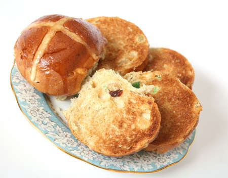 A plate of delicious, toasted hot cross buns, a traditional Easter treat.