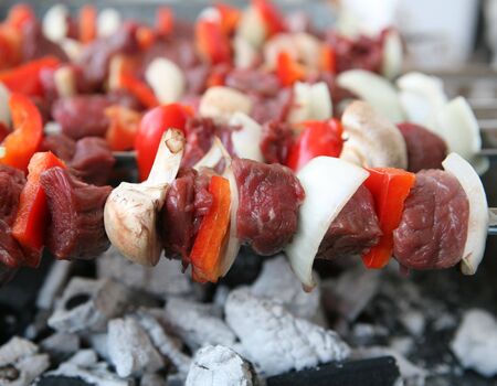 View of kebabs cooking on a barbecue grill.の写真素材