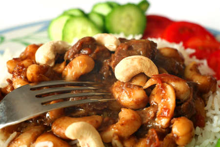 Close-up on a beef and cashew nut curry, garnished with fresh cashews.の写真素材