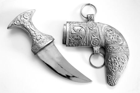 A traditional knife, or khanjar, of the kind worn with national dress in southern Arabia, especially Oman, symbolising readiness to defend one's honour. Monochrome.の写真素材