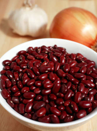 Ingredients for a curry or chili con carne or another spicy dish on a chopping board.