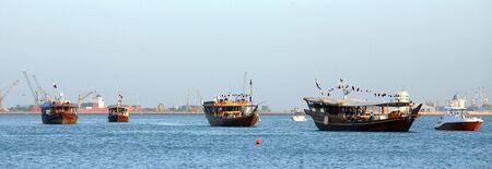 A parade of Arab dhows, decked out with Qatari flags, during Doha Cultural Week, March, 2008の写真素材